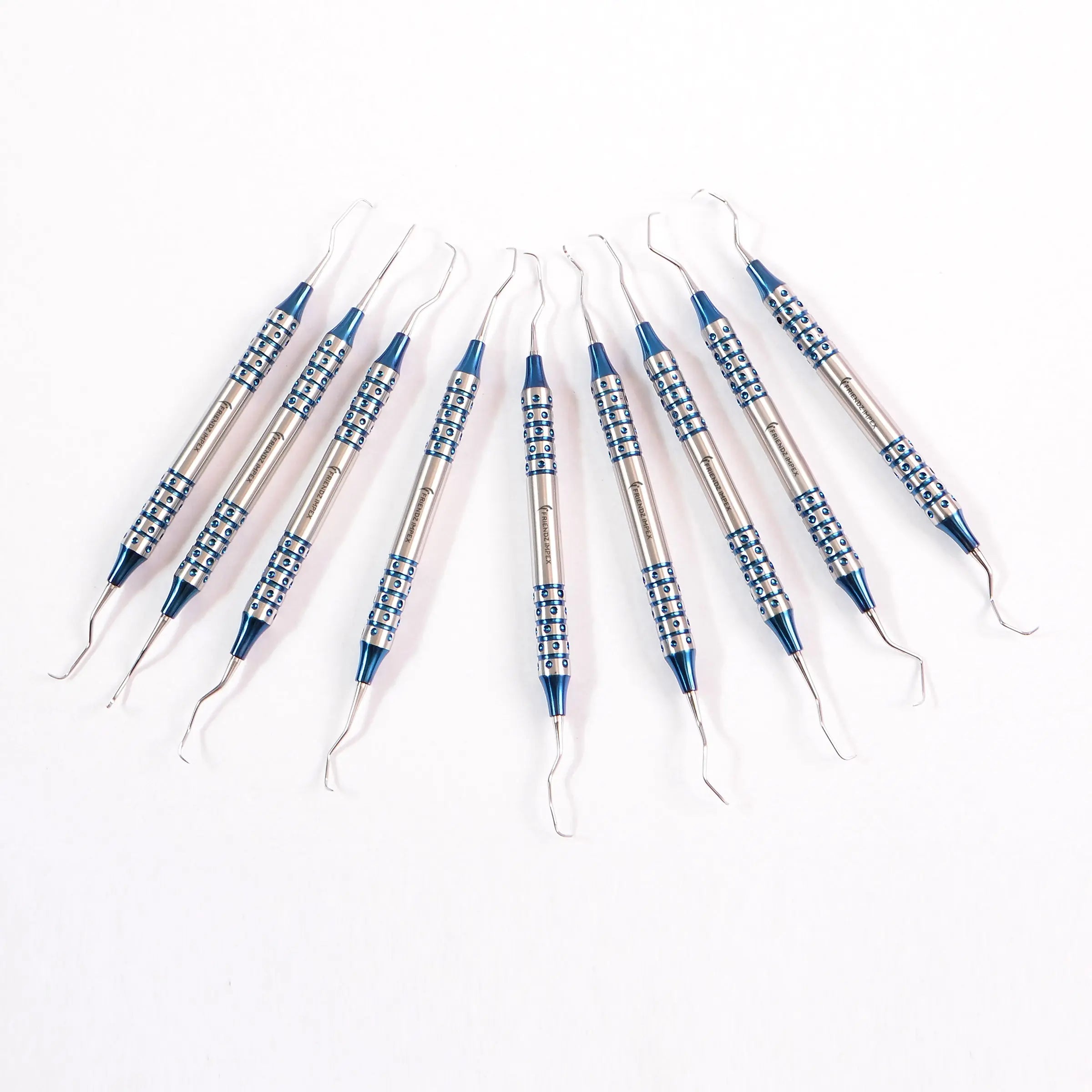 Set of stainless steel dental curettes with blue textured handles arranged on white background