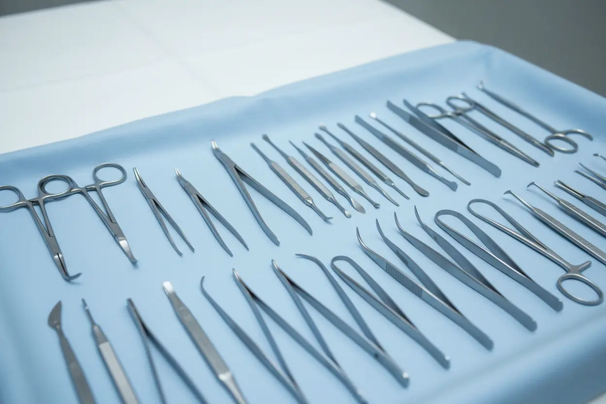 Stainless steel rhinoplasty surgical instruments set neatly arranged on blue tray.